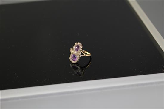 An early to mid 20th century 9ct, amethyst and seed pearl set double cluster dress ring,